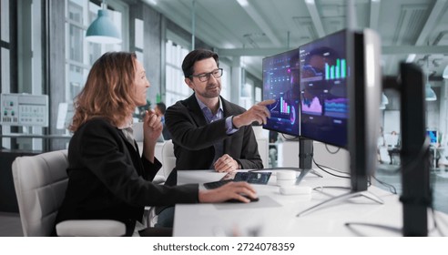 Focused Financial Analysts Analyze Computer Dashboard For Top Performance In Business