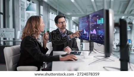 Focused Financial Analysts Analyze Computer Dashboard For Top Performance In Business