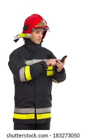 Focused Fireman Using Smart Phone. Three Quarter Length Studio Shot Isolated On White.