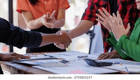 A focused group presents data analysis using graphs and charts, illustrating their collaborative effort in understanding and communicating key information effectively.