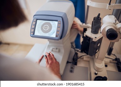 Focused Image Of Doctor Hand Managing Slit Lamp In Office Of Pediatric Optician