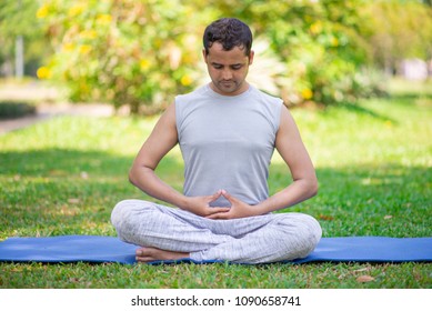 Focused Indian Guy Doing Yoga Asanas Stock Photo (Edit Now) 1249417591