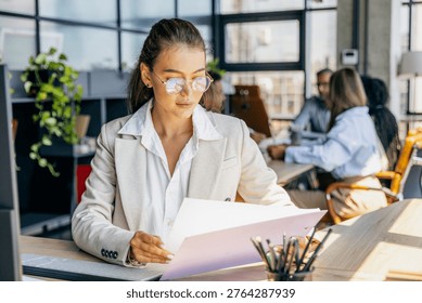 Focused individual analyzes data and documents meticulously