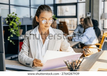 Focused individual analyzes data and documents meticulously