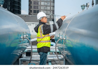 Focused industrial engineer using a calibration tool to check equipment at a manufacturing plant, ensuring operational efficiency.