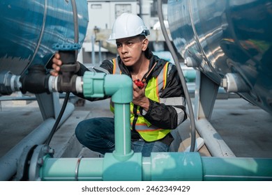 Focused industrial engineer using a calibration tool to check equipment at a manufacturing plant, ensuring operational efficiency. - Powered by Shutterstock