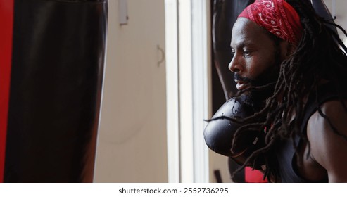 Focused male boxer practicing boxing in fitness studio - Powered by Shutterstock