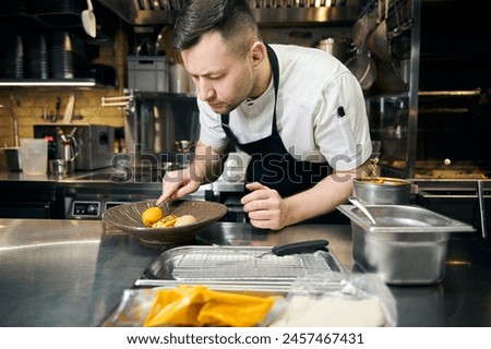 Similar – Image, Stock Photo Concentrated chef adding cream inside ceramic plate