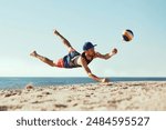 Focused man in sportswear playing beach volleyball by the sea, hitting all in jumbo and falling down in sand.. Concept of sport, summer, nature, active lifestyle, youth