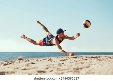 Focused man in sportswear playing beach volleyball by the sea, hitting all in jumbo and falling down in sand.. Concept of sport, summer, nature, active lifestyle, youth - Powered by Shutterstock