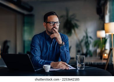 Focused man thinking about his next business project, looking thoghtful. - Shutterstock ID 2253642185