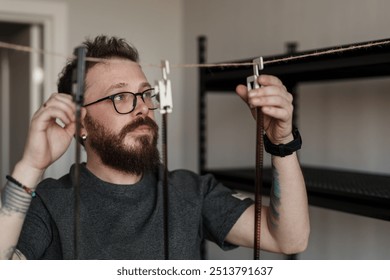 A focused man working on developing film negatives, illustrating photography development process and attention to detail. - Powered by Shutterstock