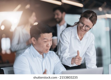 Focused Mature Female Employee Discussing Project, Showing Presentation To Skilled Team Leader. 