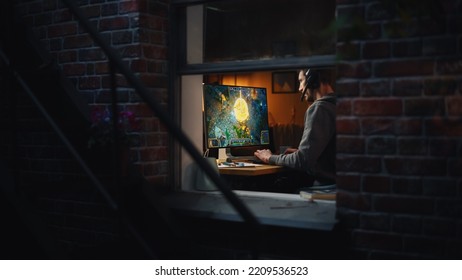 Focused Middle Aged Male Gamer Playing Online Video Game On Personal Computer. Guy Enjoying Fantasy RPG Game With Role Playing Character Casting Magic Spells, Destroy Enemies. Shot From Outdoors.