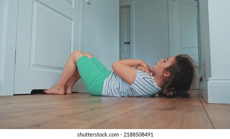 Focused Motivated Young Caucasian Girl Doing Workout At Home Exercising Sit Ups Crunches