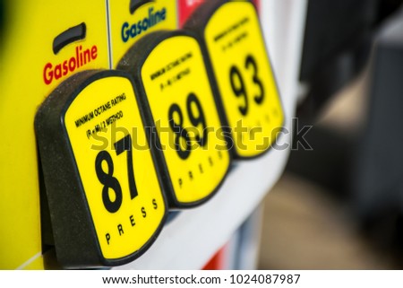 Focused on 87 Octane rating and high prices at the gas pump. Yellow buttons to choose your poison and unleaded or premium gasoline. Fossil fuels power our cars and transportation and cost is rising