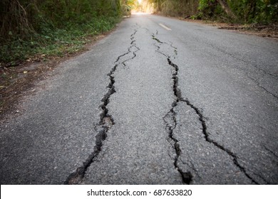 Focused On Cracked Asphalt Road.