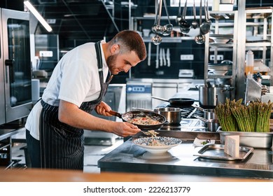 Focused on making delicious salad. Chef is on the kitchen preparing food. - Powered by Shutterstock