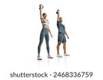 Focused on training man and woman performing kettlebell press exercise and demonstrate excellent form against white studio background. Concept of people in sport, healthy lifestyle, teamwork. Ad