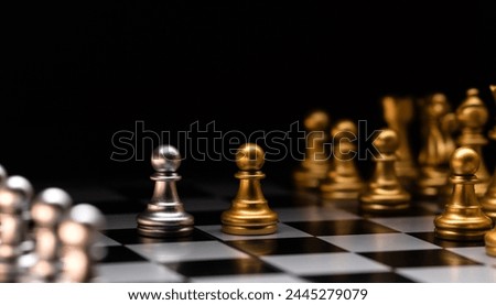 Focused pawn. Silver chess pieces and golden rivals. Chessmen on a chessboard