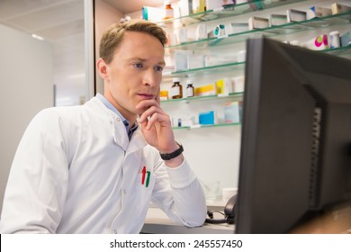 Focused Pharmacist Using The Computer At The Hospital Pharmacy