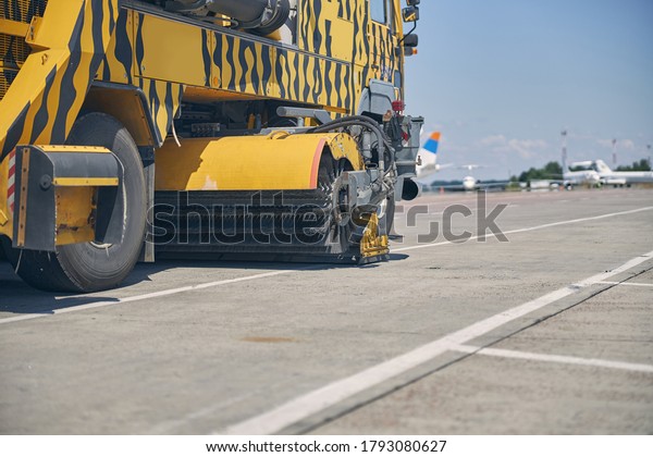 Focused photo on big auto that driving forward on\
the territory of the\
airport