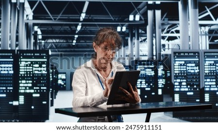 Focused IT practitioner working in high tech location housing GPU dedicated servers that can process AI tasks with high efficiency, diagnosing rigs used for machine learning showing hindrances