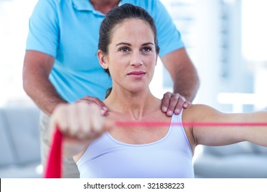 Focused Pregnant Woman Stretching Exercise Band