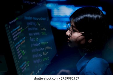 Focused programmer studies glowing code on large screen. Glasses reflect blue digital light. Calm concentration radiates from the figure. Perfect for tech, development, or innovation themes