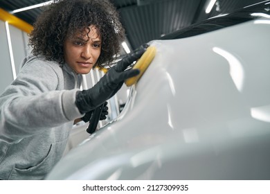 Focused Service Station Worker Polishing Car Exterior