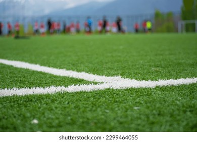 focused soccer field lines. Young soccer players training on the soccer field in the background. - Powered by Shutterstock