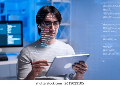 A focused software engineer reviews code on tablet in modern workspace, surrounded by glowing blue ambiance. scene reflects coding and development. coding developer software engineer