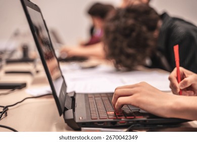 Focused Student Coding on Laptop – Side View of Young Programmer at Work