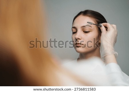 Focused Studio Session Where Technician Marks Eyebrows Meticulously For Noninvasive Lifting Procedure
