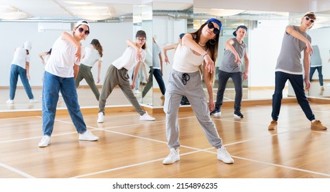 Focused Teenage Hip Hop Dancers Doing Dance Workout During Group Class