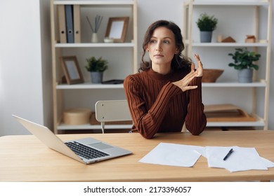 Focused Thoughtful Unhappy Sad Curly Beautiful Woman Lost In Heavy Thoughts Looks Aside Think About Difficult Life Decision Sitting At Home Office. People Problems Concept