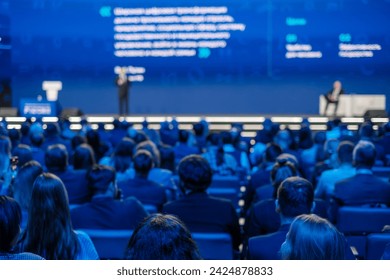 Focused view on corporate audience listening to a presenter at a professional conference event. - Powered by Shutterstock