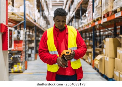 Focused warehouse worker using barcode scanner to track packages, ensuring efficient logistics and inventory management in distribution center