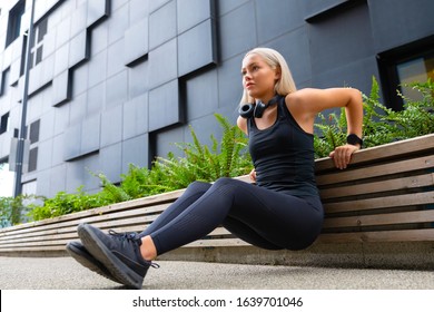 Focused Woman Doing Heavy Triceps Dips Outdoor in the City