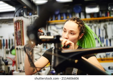 Focused Woman Fixing Bike Handlebar