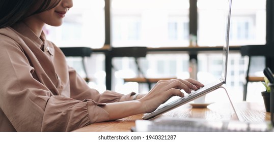 Focused woman journalist freelancer working online on laptop, sitting at desk at home, looking at screen, typing, serious young female writing blog or chatting with friends in social network - Shutterstock ID 1940321287