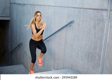 Focused Woman Running Up Stairs