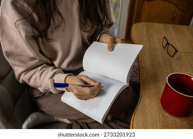 Focused Writing Session with Notebook and Pen