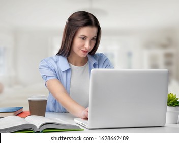 Focused young businesswoman or student looking at laptop - Shutterstock ID 1628662489