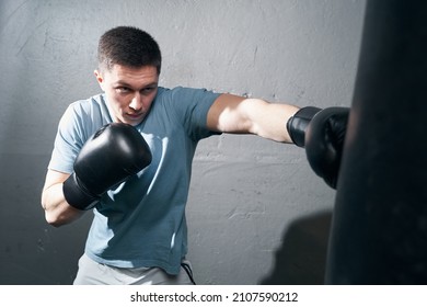 Focused Young Caucasian Male Boxer Training Indoors