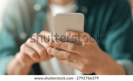 Focused Young Man Using Smartphone Touchscreen In Modern Office, Digital Communication Concept
