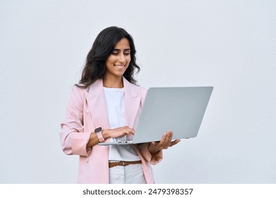 Focused young middle eastern Israel businesswoman using laptop pc online application for work isolated on white wall. Indian or arabic woman in business suit holding computer, doing data base research - Powered by Shutterstock