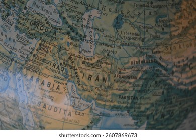Focusing on a section of a globe, this view reveals the geographical layout of Iran and Afghanistan alongside neighboring countries, showcasing their borders and locations.