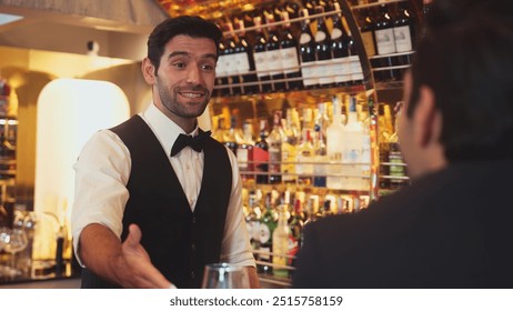 Focusing on smiling smart bartender preparing drinks at luxurious bar while engaging lively conversation with VIP customer at vibrant warm lighting atmosphere bottle bar and pub background. Vinosity. - Powered by Shutterstock