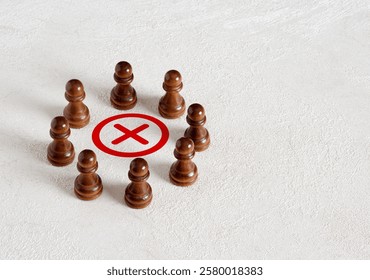 Focusing on the wrong choice. Voting no or making the wrong collective decision. Cancellation or rejection. A group of people gathered around the x mark.